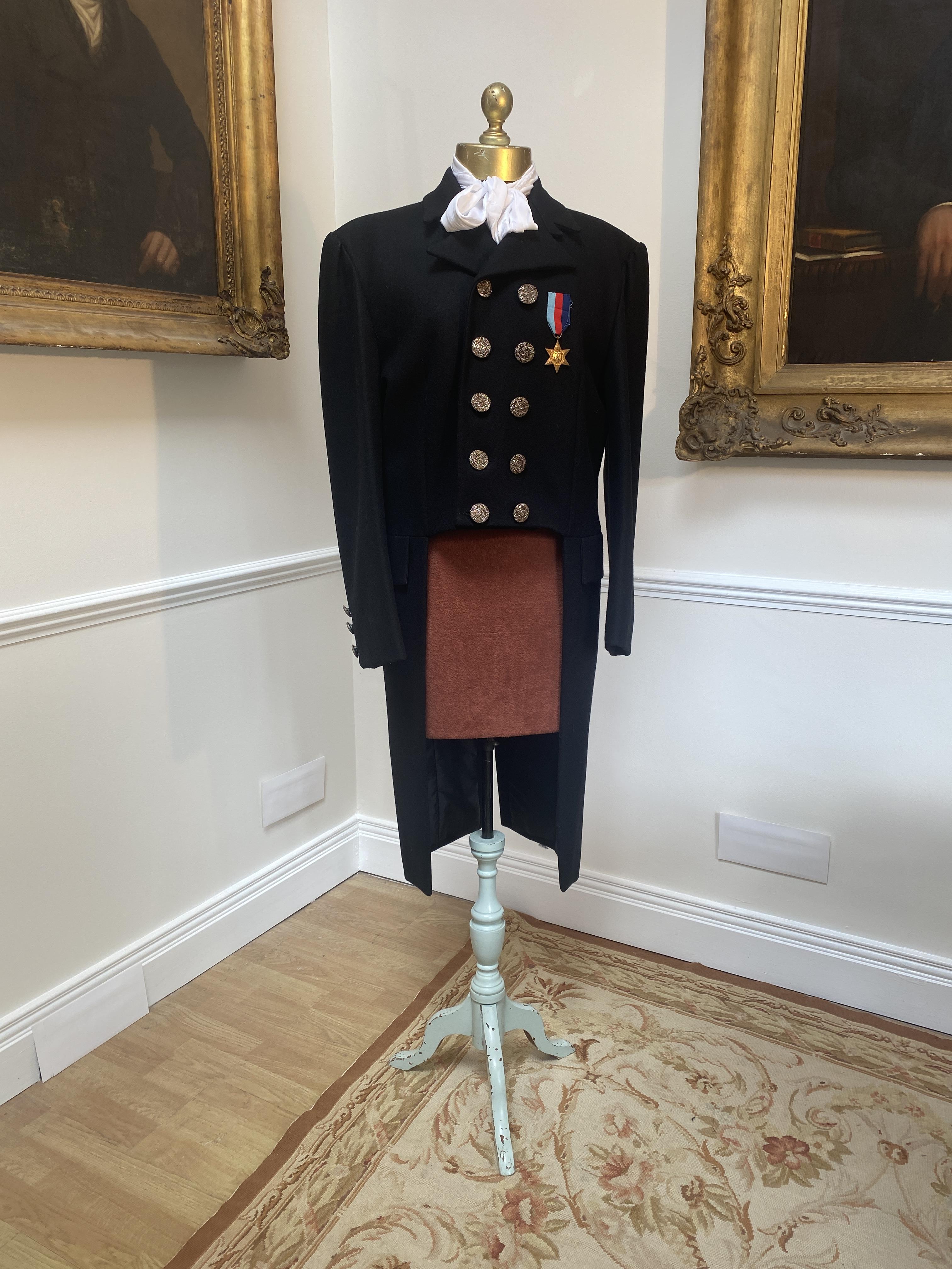 A men’s Regency style military jacket with medal. Size Medium